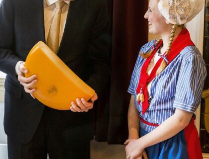 King Willem-Alexander of the Netherlands (L) holds a cheese during the reopening ceremony of the Cheese Museum in Alkmaar, on March 6, 2014. The museum, that opened in 1983 and is located in the Waaggebouw (Weighing Building), has been renovated.   AFP PHOTO / ANP / REMKO DE WAAL   ***netherlands out***